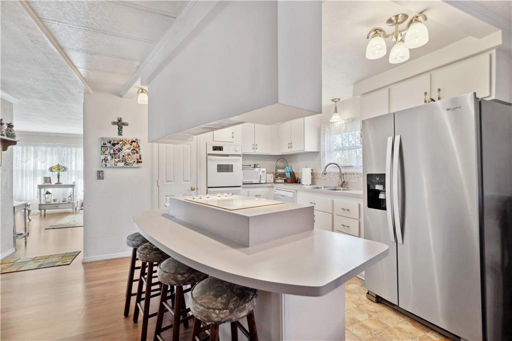 476 Cecil-Henderson Road Cecil, PA 15321 - Photo 11 of 37 a kitchen with white cabinets and stainless steel appliances