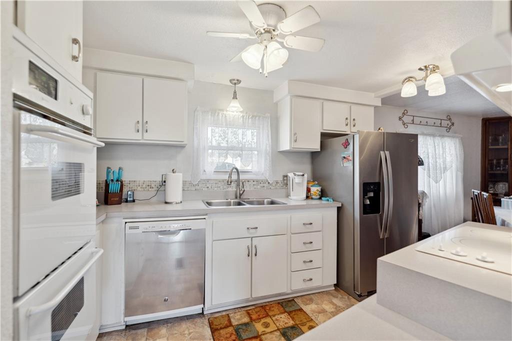 476 Cecil-Henderson Road Cecil, PA 15321 - Photo 10 of 37 a kitchen with cabinets stainless steel appliances and a chandelier