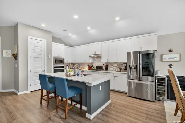 a kitchen with a sink a counter top stainless steel appliances and cabinets