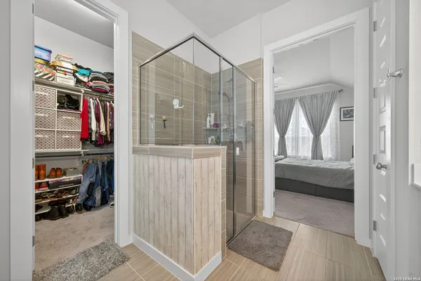 a view of a bedroom with closet and windows