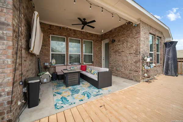 a living room with patio furniture and a fireplace