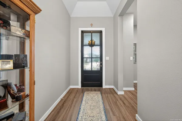 a view of hallway with wooden floor