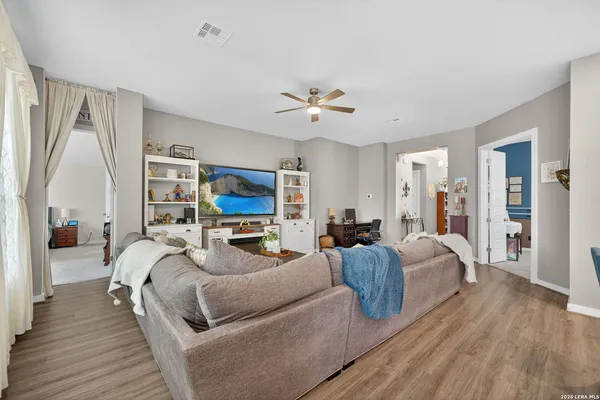 a bedroom with furniture and a flat screen tv
