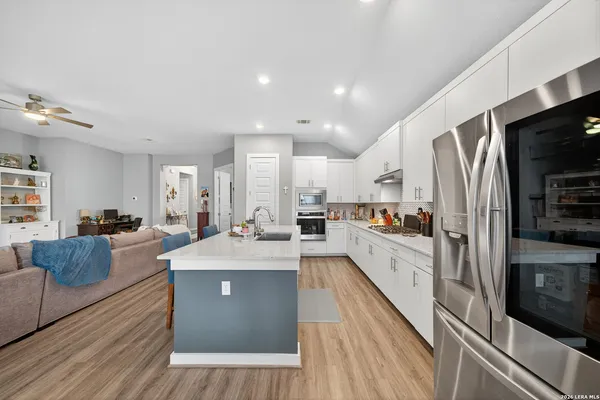 a large kitchen with stainless steel appliances lots of counter top space
