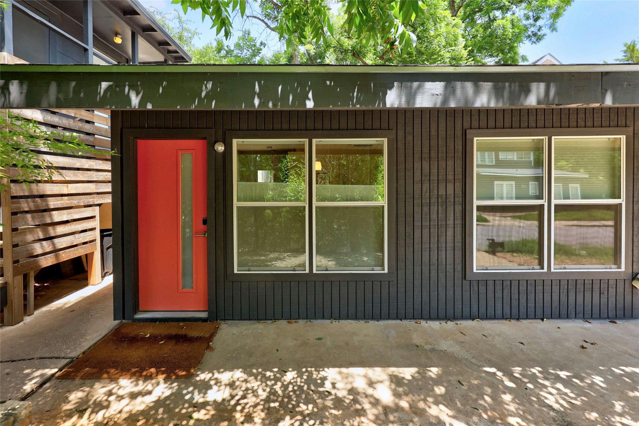 2201 Leon Street Austin, TX 78705 - Photo 3 of 30 A vibrant red door welcomes guests to this modern dwelling, framed by clean lines and ample natural light.
