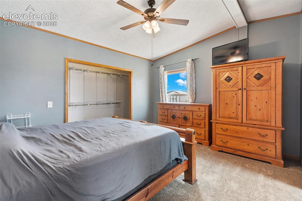 1350 South Calhan Highway Yoder, CO 80864 - Photo 29 of 45 Bedroom featuring a ceiling fan, light gray wall color, and carpet flooring