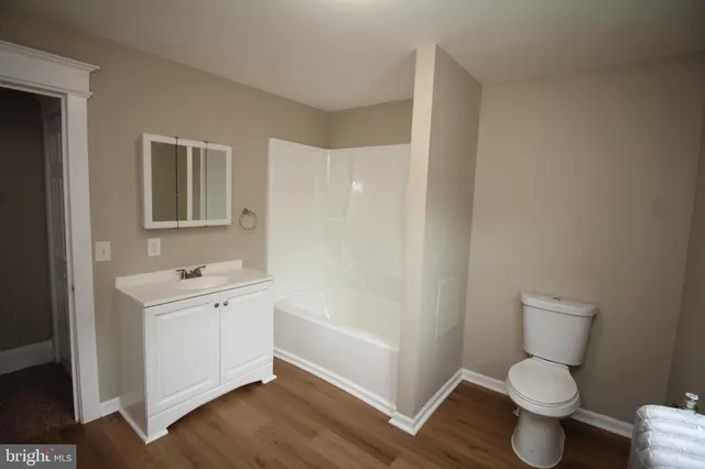 a bathroom with a toilet a sink and bathtub