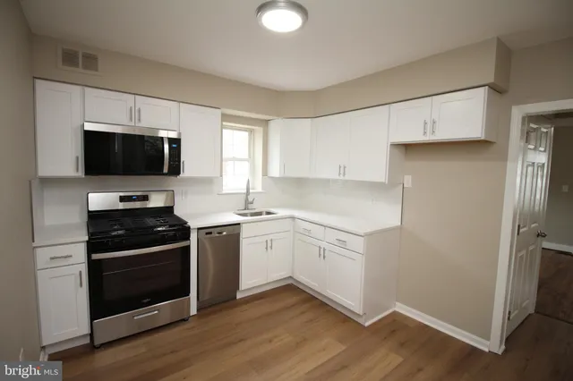 a kitchen with a sink stove and microwave