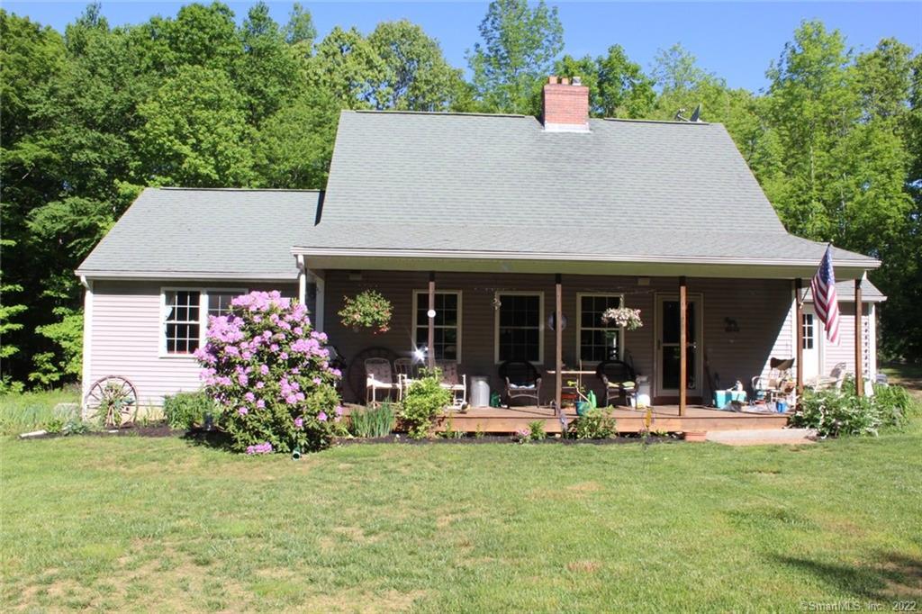 Beautiful Cape on over 10 acres with mature plantings a welcoming front porch.