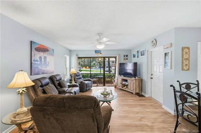 a living room with furniture large window and flat screen tv