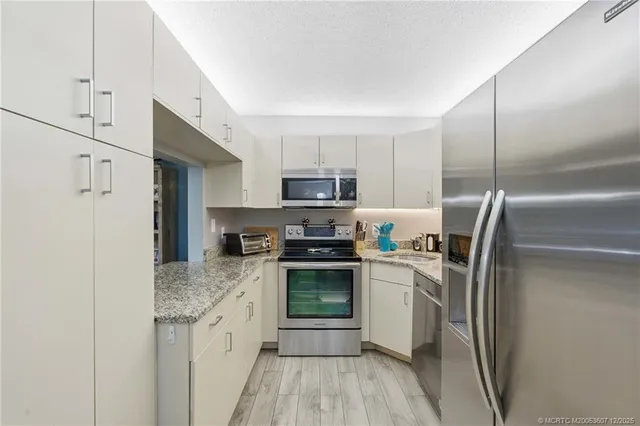 a kitchen with a refrigerator stove and microwave