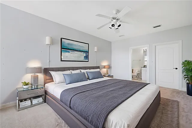 a bedroom with a bed and a potted plant