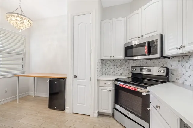 a kitchen with stainless steel appliances granite countertop a sink and a stove