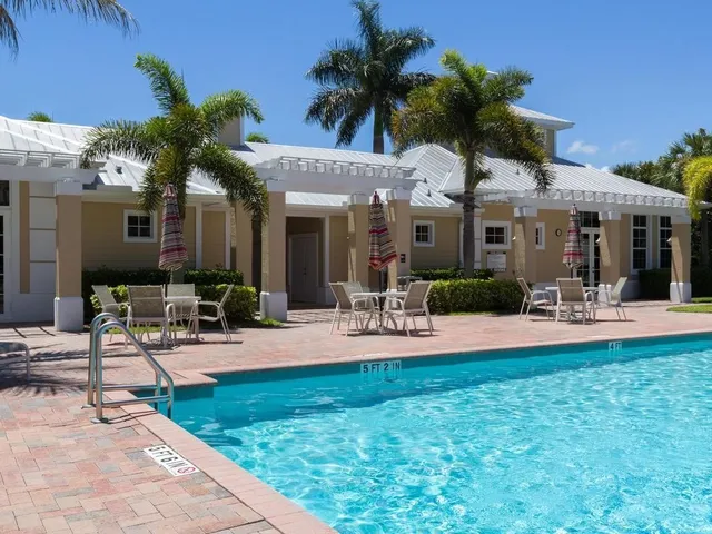 a swimming pool with outdoor seating and yard