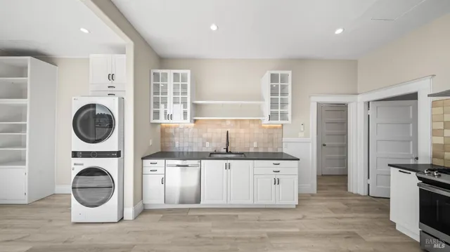 a kitchen with a stove top oven sink and cabinets
