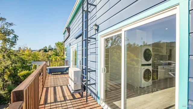 a view of a house with a yard and a large tree