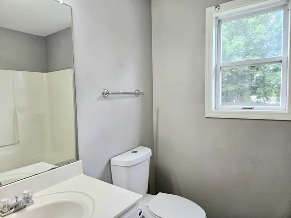 a white toilet sitting next to a bathroom sink