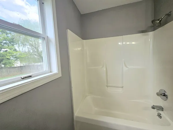 a bathroom with a bathtub and a shower