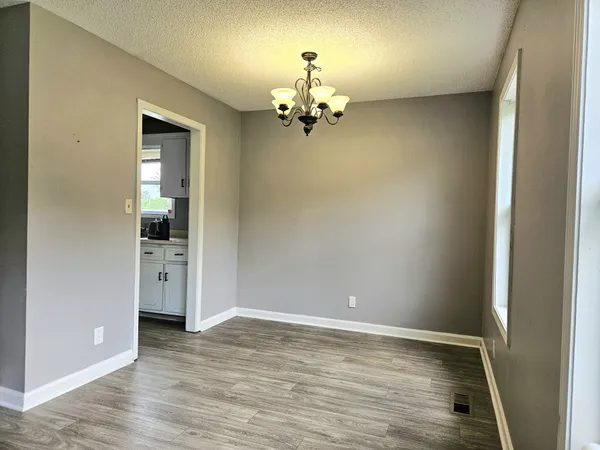 wooden floor in an empty room with a mirror