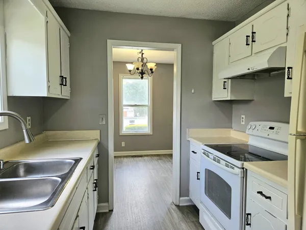 a kitchen that has a sink and a stove