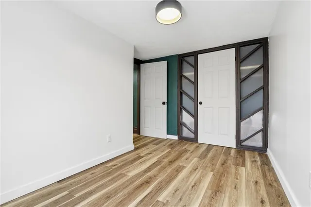 a view of a room with wooden floor and bathroom