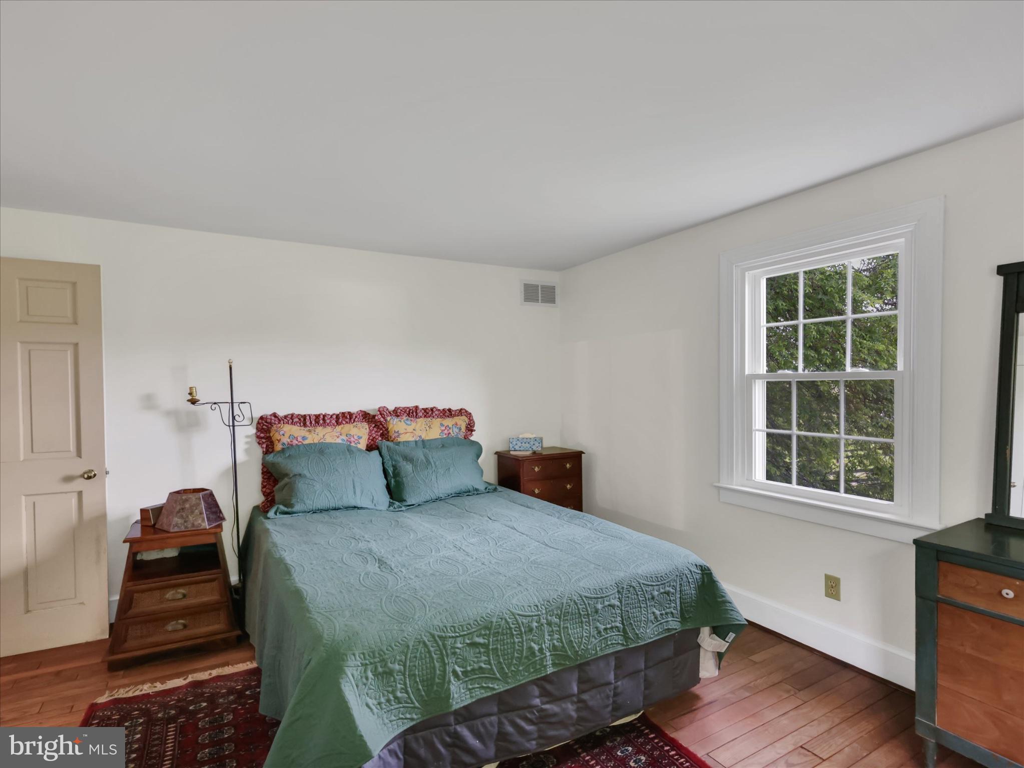 19255 Telegraph Springs Road Purcellville, VA 20132 - Photo 39 of 107 a bedroom with a bed and wooden floor