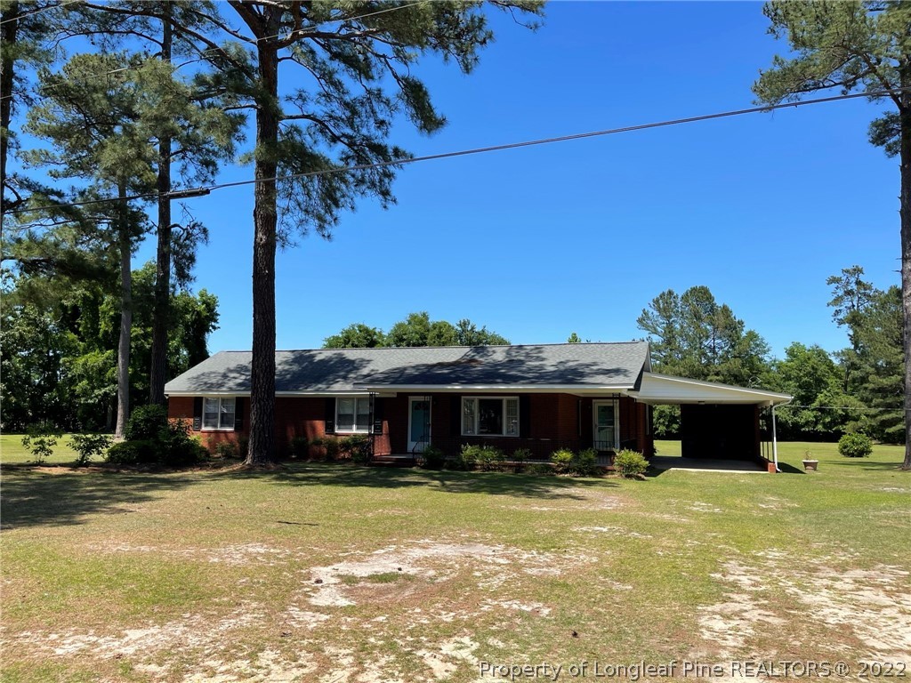 1500 Meadowlark Road Dunn, NC 28334 - Photo 1 of 19 a front view of a house with a garden