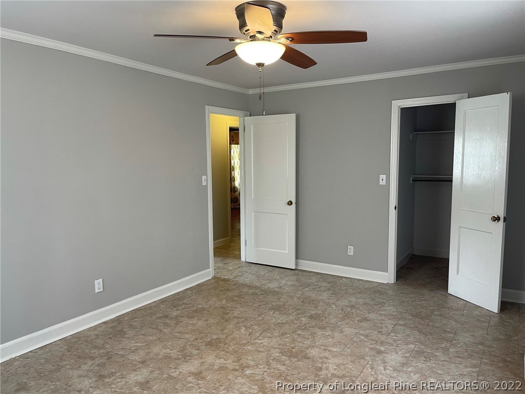 1500 Meadowlark Road Dunn, NC 28334 - Photo 12 of 19 an empty room with closet and a chandelier fan