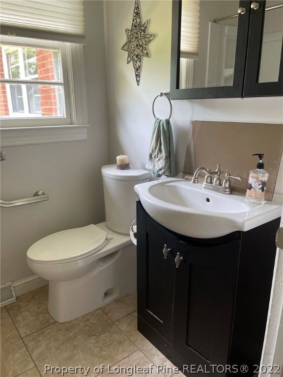 1500 Meadowlark Road Dunn, NC 28334 - Photo 18 of 19 a bathroom with a sink and a toilet