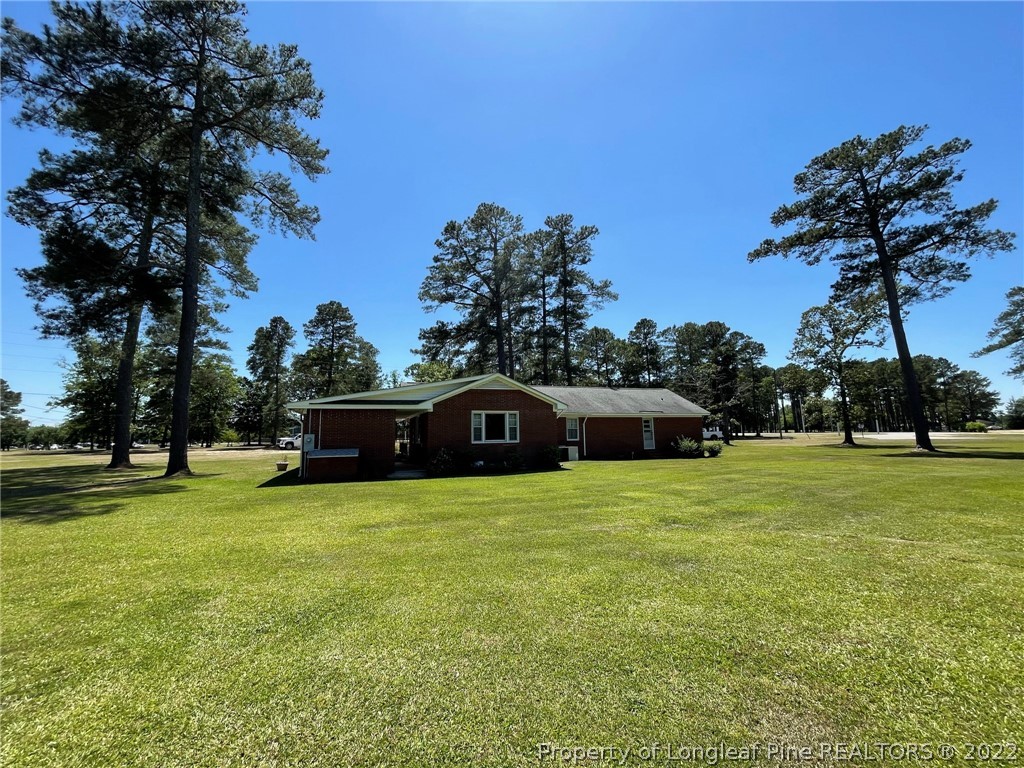 1500 Meadowlark Road Dunn, NC 28334 - Photo 2 of 19 a front view of a house with garden