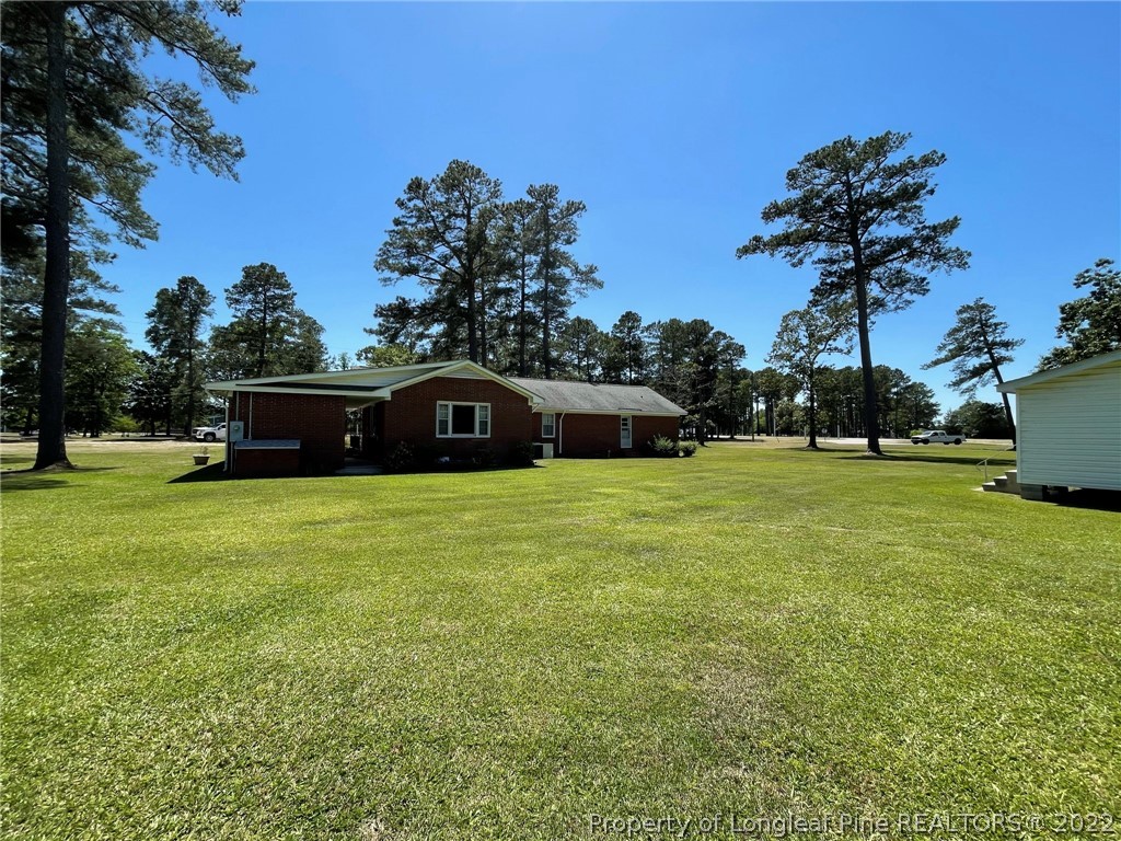 1500 Meadowlark Road Dunn, NC 28334 - Photo 3 of 19 a front view of a house with a garden