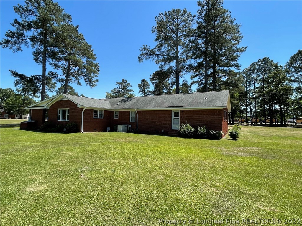 1500 Meadowlark Road Dunn, NC 28334 - Photo 4 of 19 a front view of a house with a garden