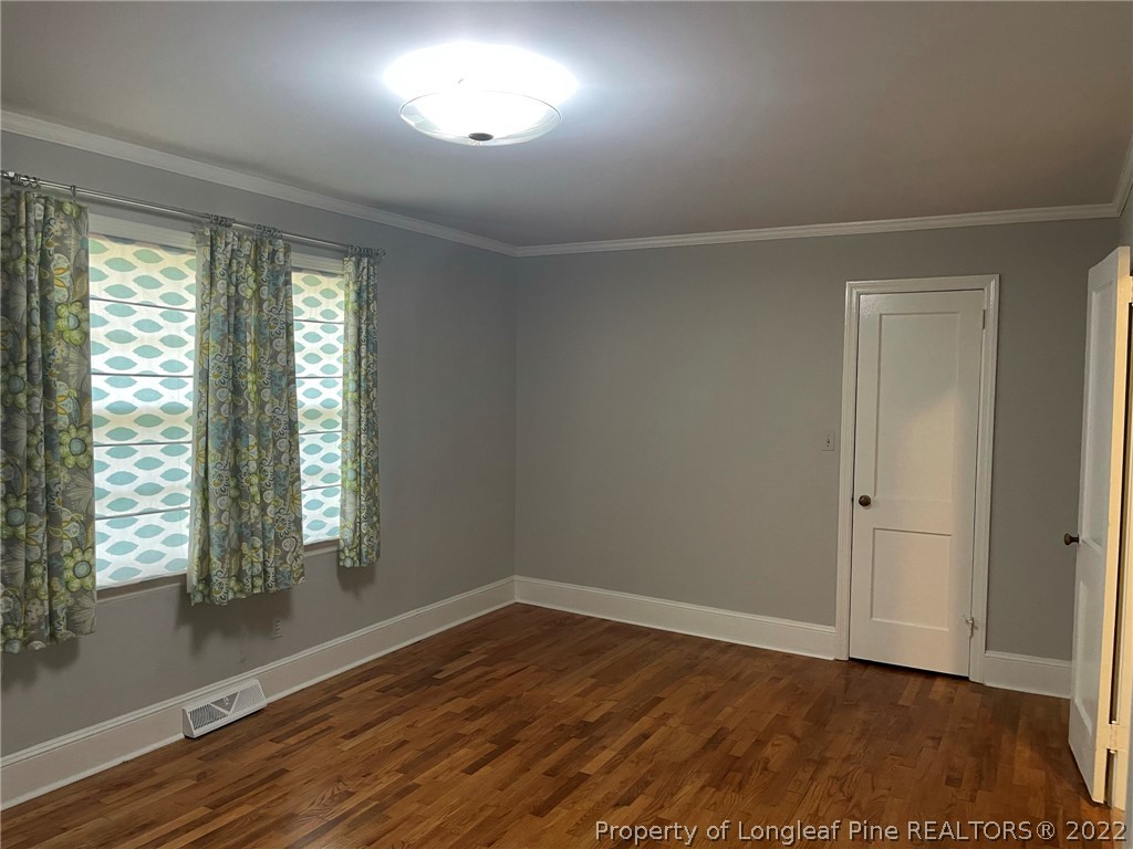 1500 Meadowlark Road Dunn, NC 28334 - Photo 9 of 19 an empty room with wooden floor and windows