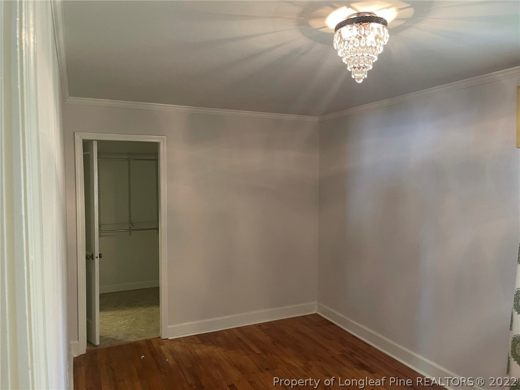1500 Meadowlark Road Dunn, NC 28334 - Photo 10 of 19 an empty room with a chandelier fan