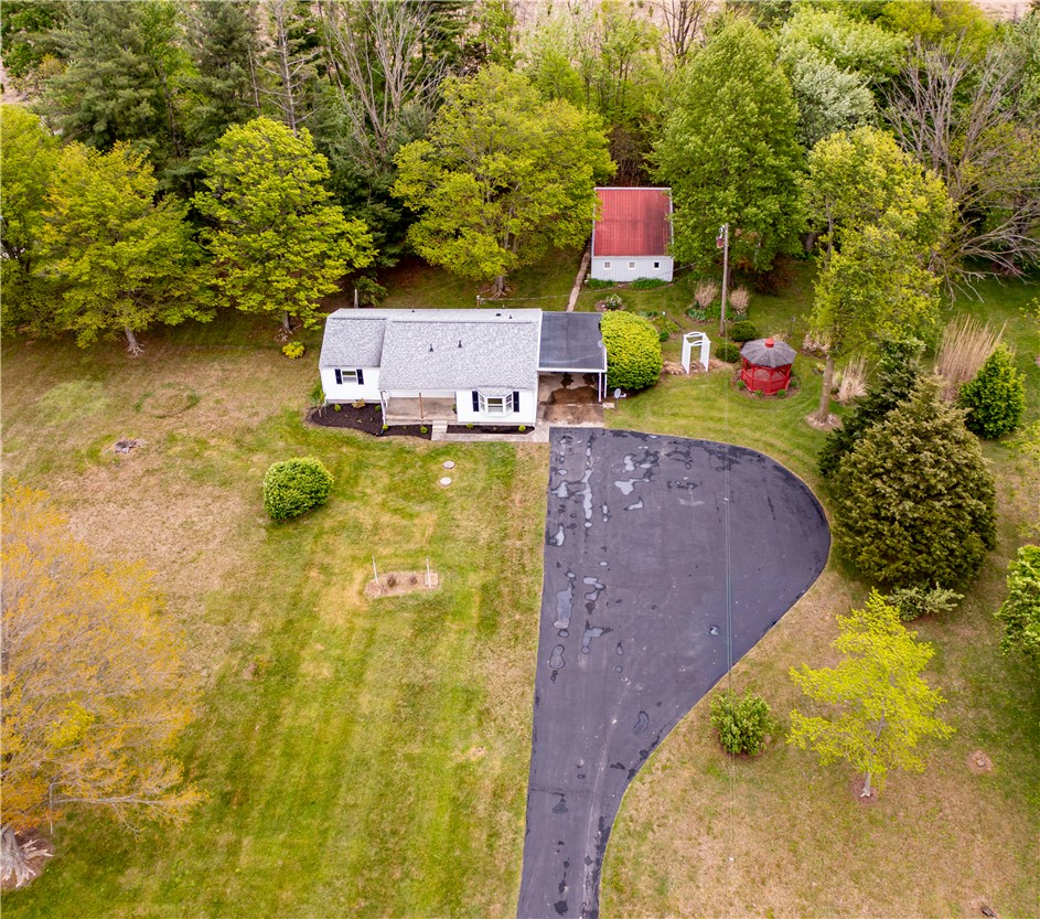 11296 Pansing Road Brookville, OH 45309 - Photo 51 of 53 This elevated view captures a home nestled among lush trees, featuring a paved driveway and green surroundings.