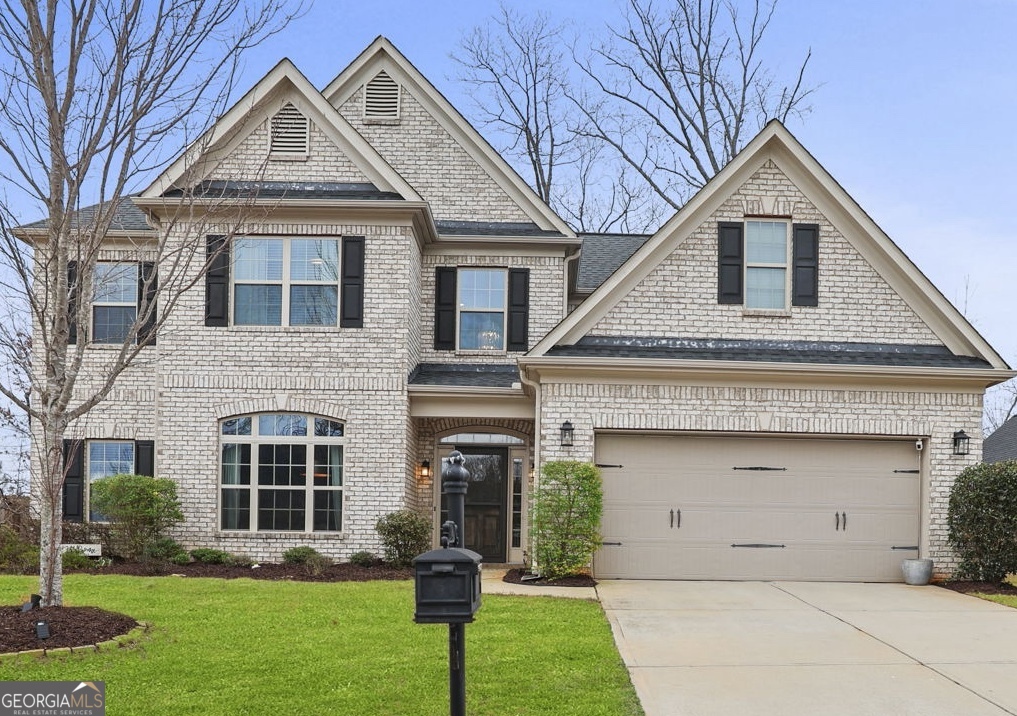 104 Stonebridge Boulevard Newnan, GA 30265 - Photo 1 of 1 a front view of a house with a yard and trees