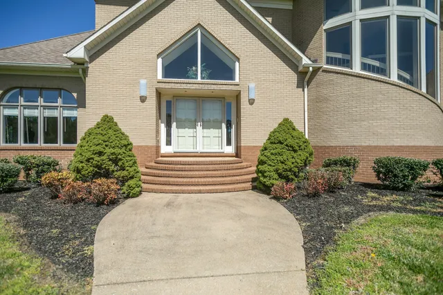 a front view of a house with garden