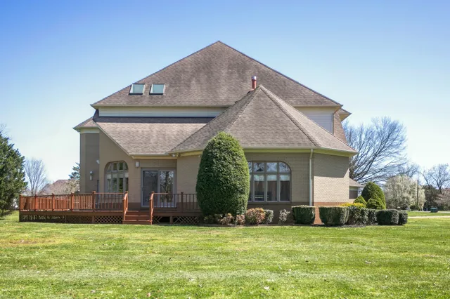 a view of a house with a yard and plants
