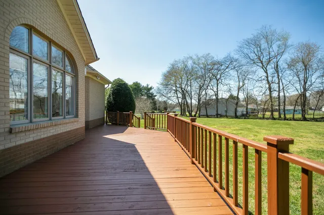 a view of a house with backyard and deck
