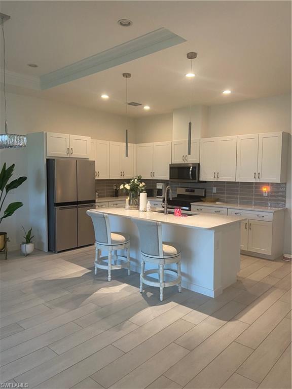 14866 Loggerhead Drive Naples, FL 34120 - Photo 4 of 16 a kitchen with stainless steel appliances granite countertop a refrigerator sink and cabinets