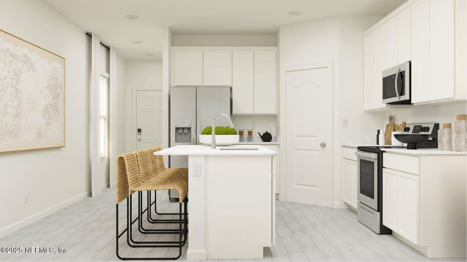 81 Pentwater Road St. Augustine, FL 32092 - Photo 22 of 38 a kitchen with a refrigerator and white cabinets