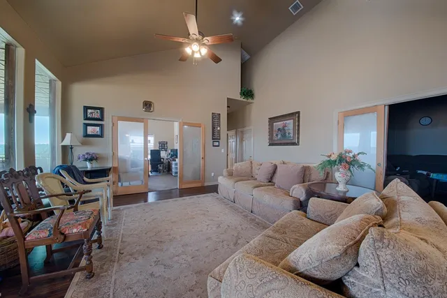 a living room with furniture and a chandelier