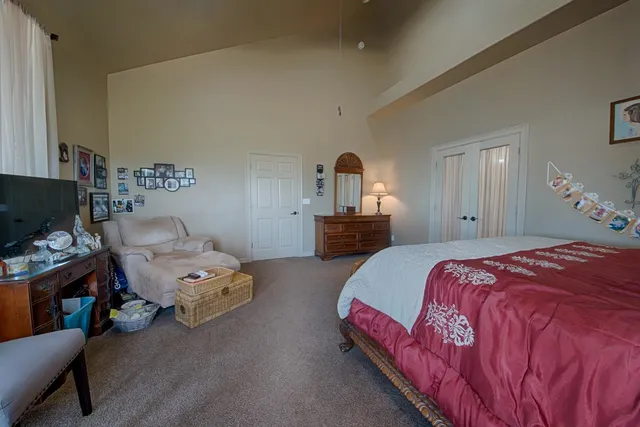 a bedroom with bed and a window