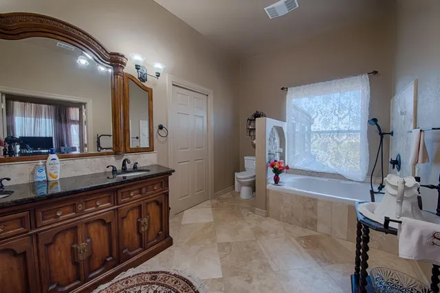 a bathroom with a sink a vanity and a mirror