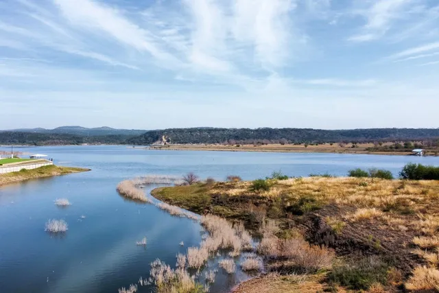 a view of a lake with houses in the back