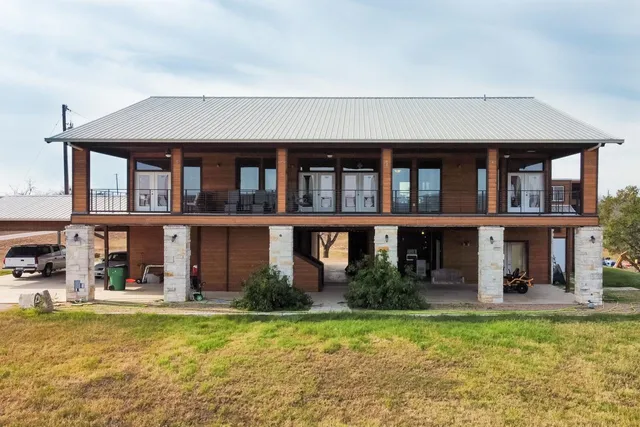 a front view of a house with swimming pool having outdoor seating