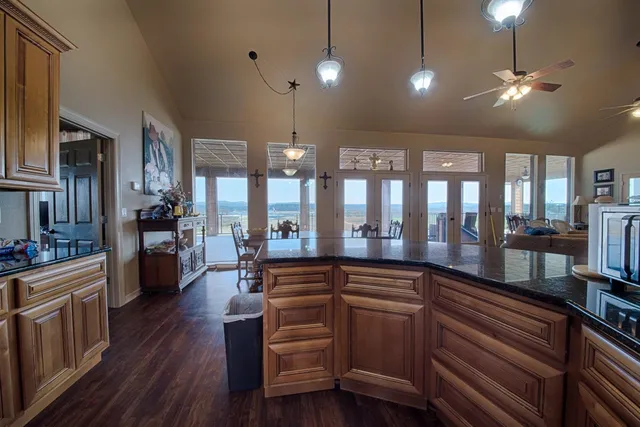 a kitchen with a sink and wooden floor