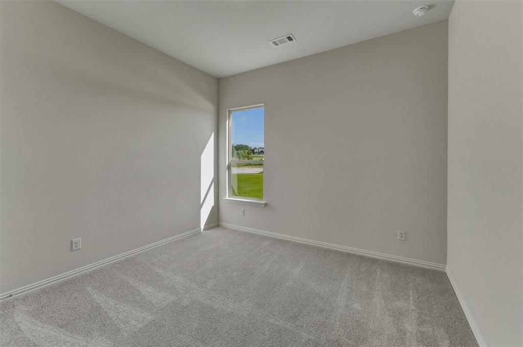605 Tay Tay Way Springtown, TX 76082 - Photo 14 of 31 Bright interior space featuring light gray wall paint, gray patterned carpet, and a white framed window