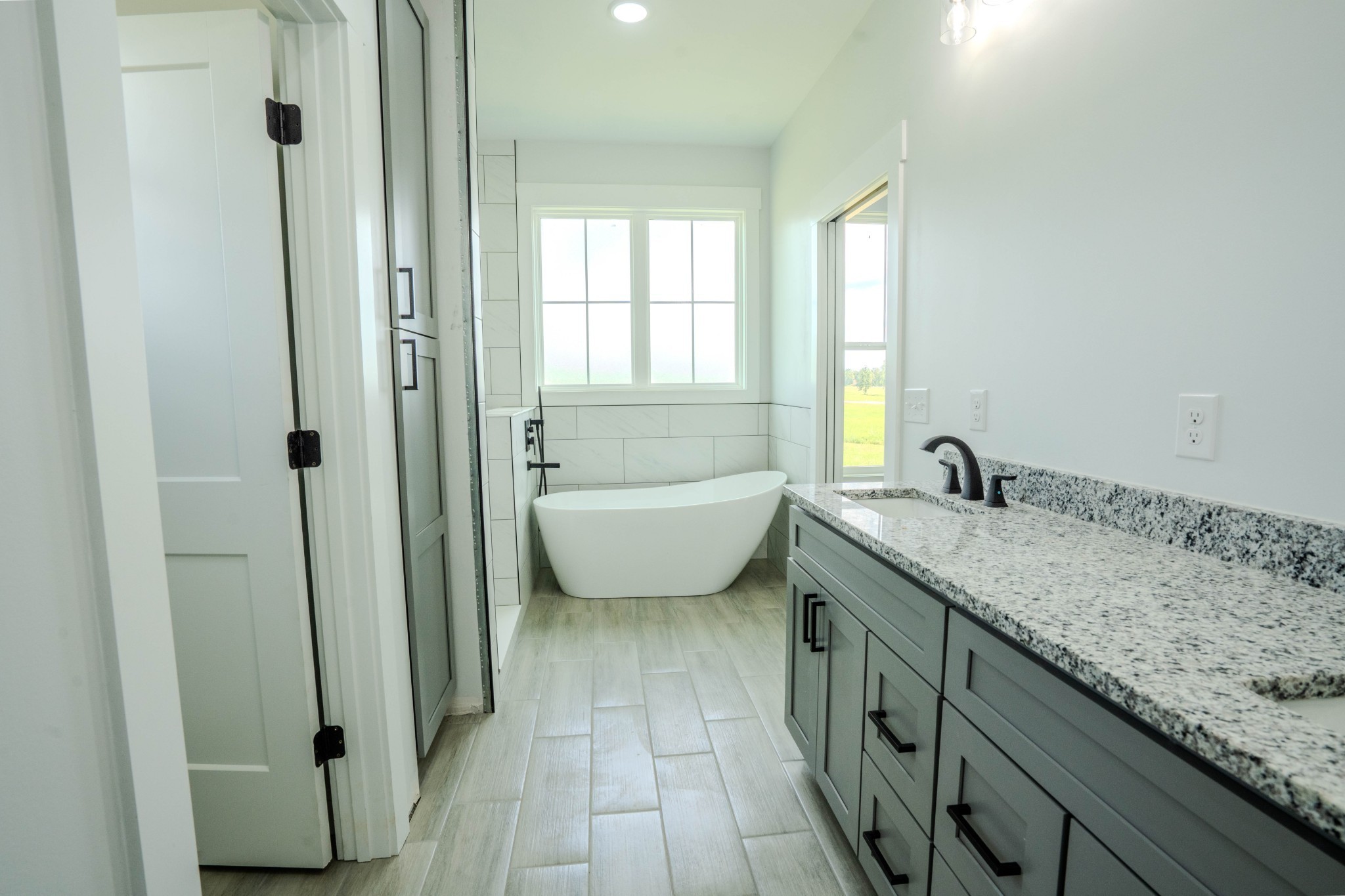 176 Beartown Road Loretto, TN 38469 - Photo 34 of 46 a spacious bathroom with a granite countertop sink and a mirror