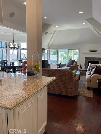 a kitchen with counter top space and living room